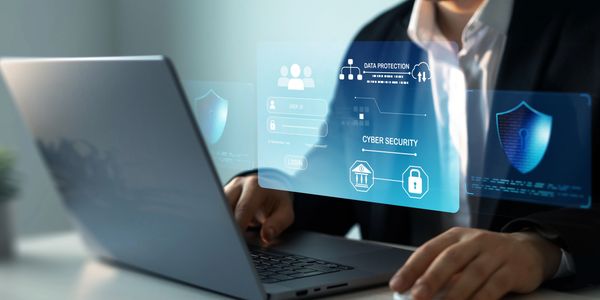 Cybersecurity professional at laptop